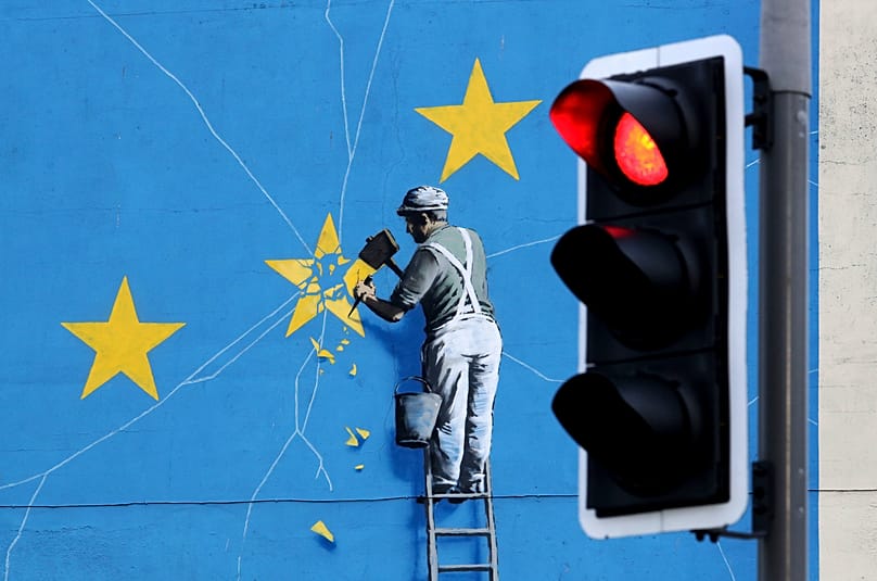 Banksy Brexit mural of a man chipping away at the EU flag in Dover, England